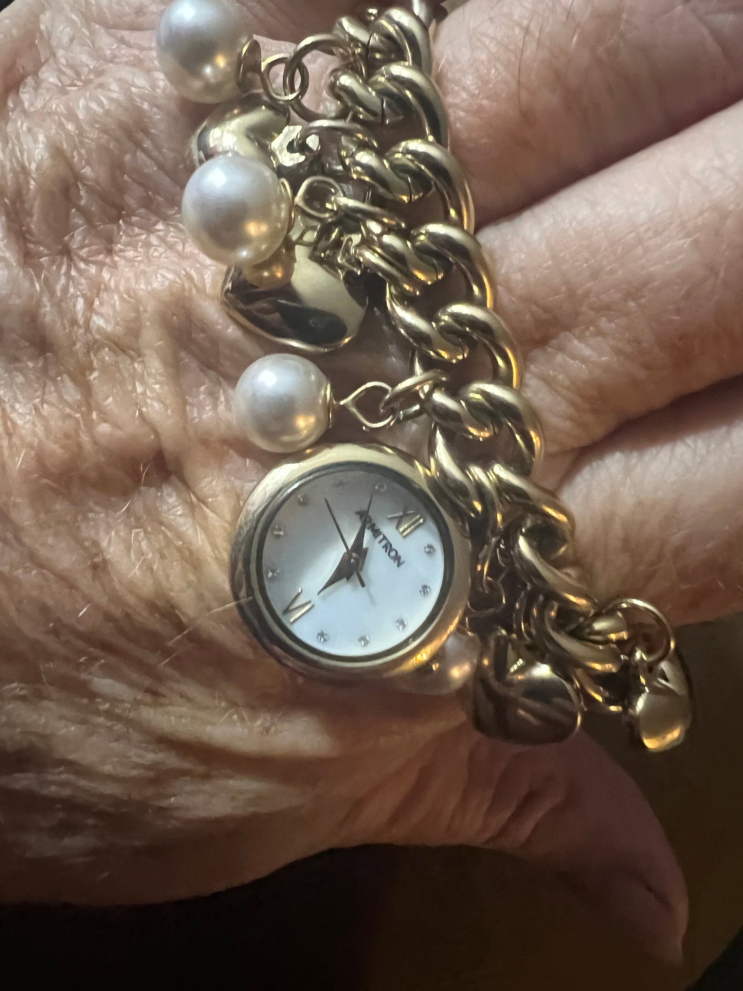 Chunky dangle ladies watch with “Pearl” accent and golden hearts Armitron 7516. New battery. Comes with gift bag